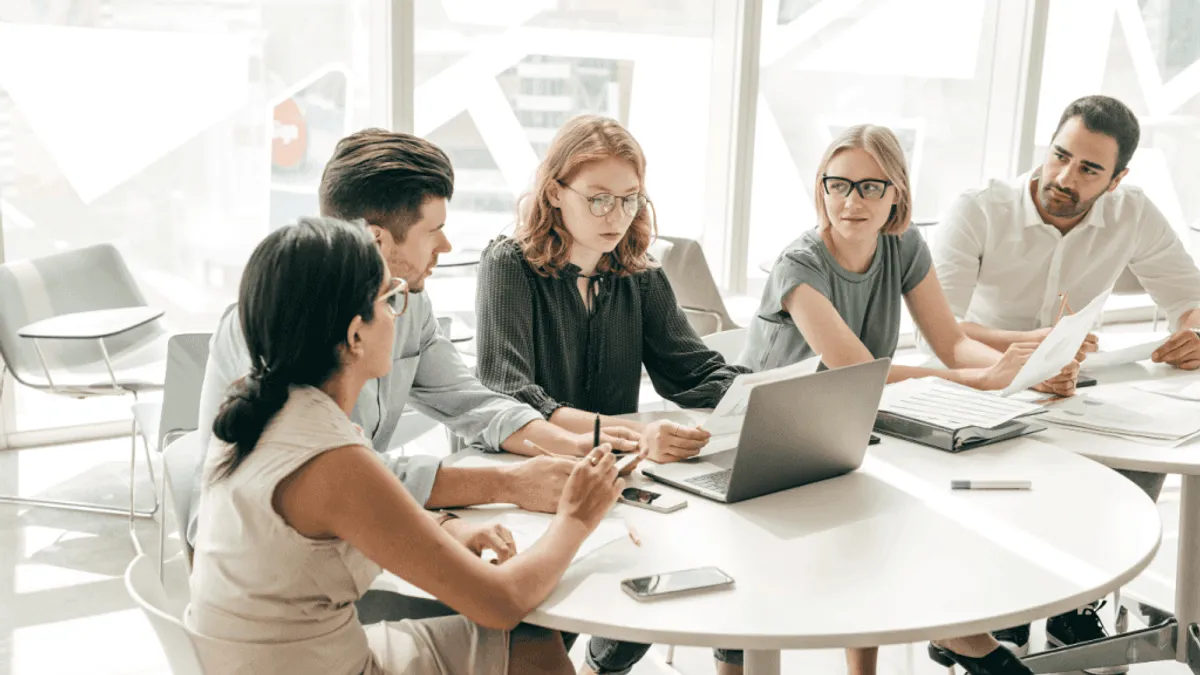 A team discussing the challenges of using an AI powered tool and generative AI for managing different social media channels