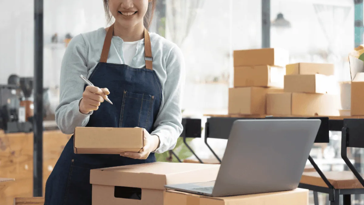 A person using a laptop to manage inventory of an ecommerce business
