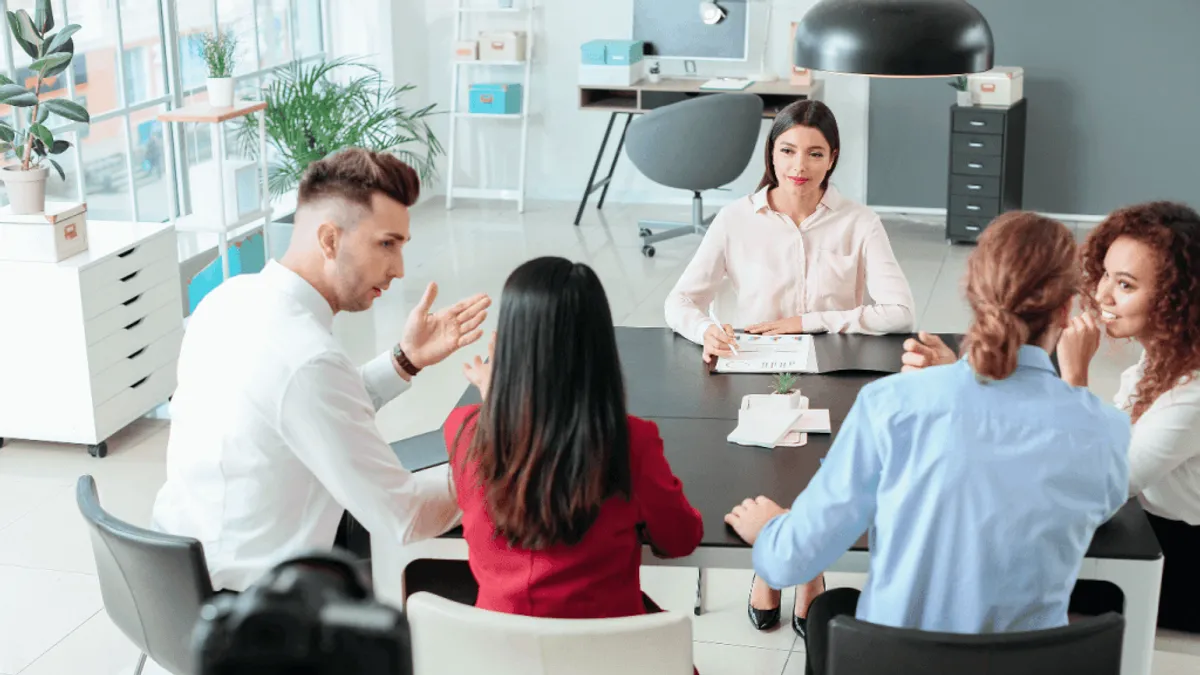 A group of HR professionals discussing the role of AI in Human Resources