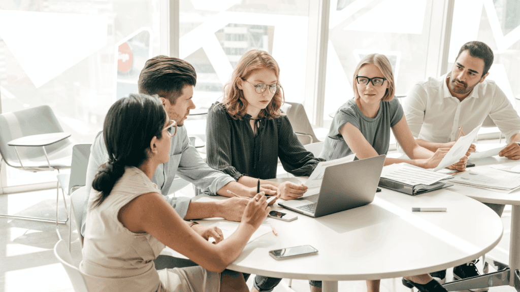 A team discussing the challenges of using an AI powered tool and generative AI for managing different social media channels
